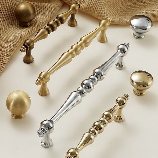 Collection of gold and silver cabinet handles on a neutral background